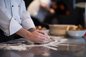 Image showing chef hands preparing dough for pizza