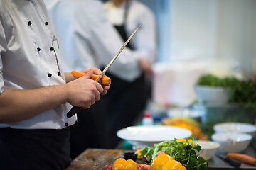 Image showing chef hands cutting carrots