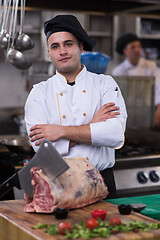 Image showing chef cutting big piece of beef