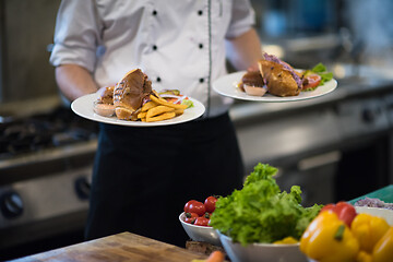 Image showing Chef showing dishes of tasty meals