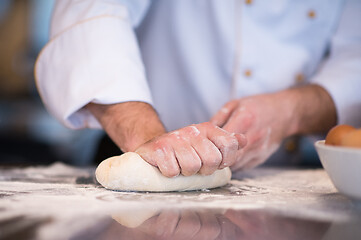 Image showing chef hands preparing dough for pizza