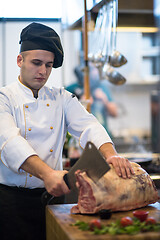 Image showing chef cutting big piece of beef