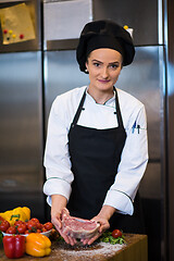 Image showing Chef holding juicy slice of raw steak