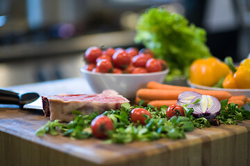 Image showing Juicy slice of raw steak on wooden table