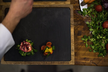 Image showing top view of Chef hands serving beef steak