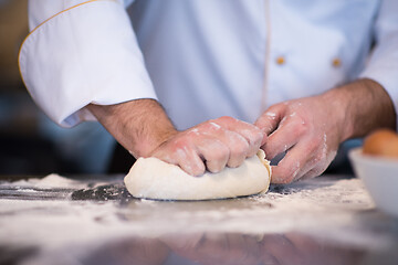 Image showing chef hands preparing dough for pizza