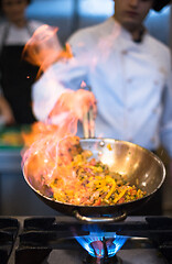 Image showing Chef doing flambe on food