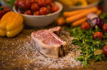 Image showing Juicy slice of raw steak on wooden table