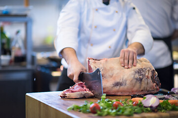 Image showing chef cutting big piece of beef