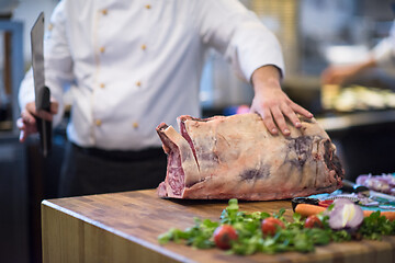 Image showing chef cutting big piece of beef