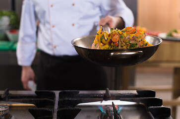 Image showing chef flipping vegetables in wok