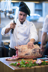 Image showing chef cutting big piece of beef