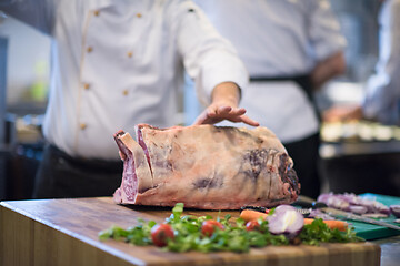 Image showing chef cutting big piece of beef