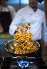 Image showing chef flipping vegetables in wok