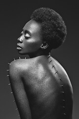 Image showing Beautiful black girl with metal pins