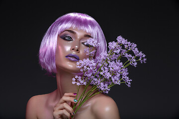 Image showing Beautiful girl in purple wig with flowers