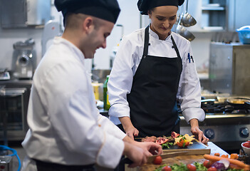 Image showing team cooks and chefs preparing meal