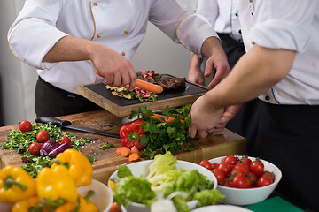 Image showing team cooks and chefs preparing meal