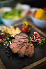 Image showing Juicy slices of grilled steak on wooden board