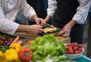 Image showing team cooks and chefs preparing meal