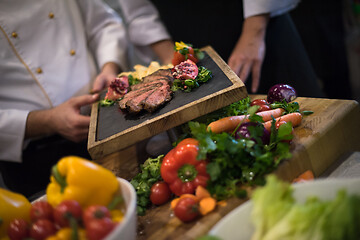 Image showing team cooks and chefs preparing meal