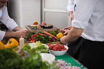 Image showing team cooks and chefs preparing meal