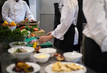 Image showing team cooks and chefs preparing meal