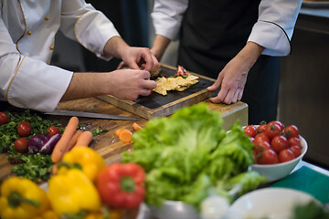 Image showing team cooks and chefs preparing meal