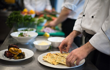 Image showing team cooks and chefs preparing meal