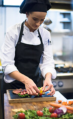 Image showing female Chef preparing beef steak