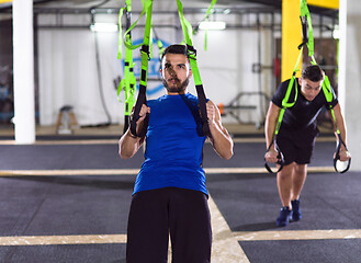 Image showing men working out pull ups with gymnastic rings