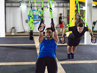 Image showing men working out pull ups with gymnastic rings