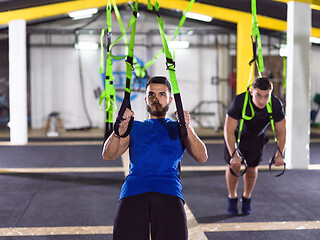 Image showing men working out pull ups with gymnastic rings