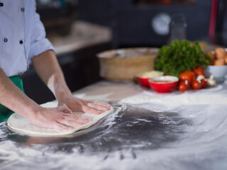 Image showing chef preparing dough for pizza