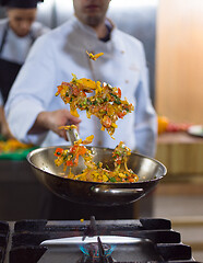 Image showing chef flipping vegetables in wok