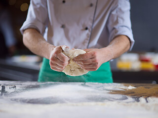 Image showing chef hands preparing dough for pizza