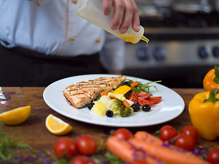 Image showing Chef finishing steak meat plate