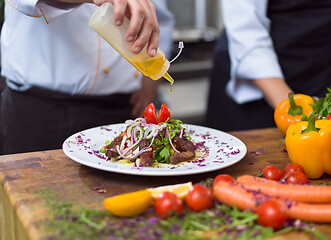 Image showing Chef finishing steak meat plate