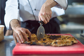 Image showing chef cutting baked bread