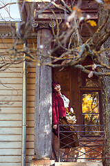 Image showing Girl standing on old house balcony