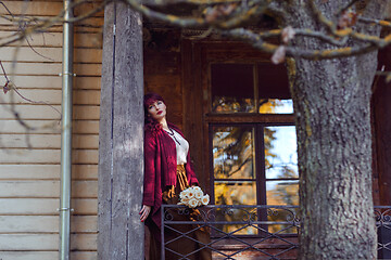 Image showing Girl standing on old house balcony