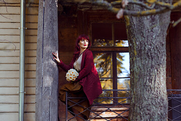 Image showing Girl sitting on old house balcony