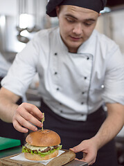 Image showing chef finishing burger