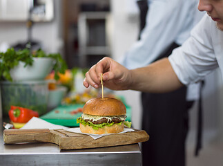 Image showing chef finishing burger