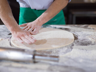 Image showing chef preparing dough for pizza