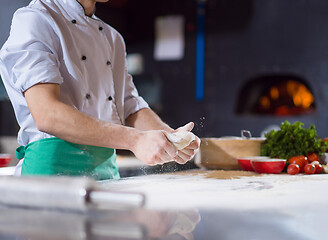 Image showing chef hands preparing dough for pizza