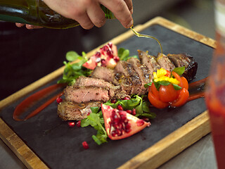 Image showing Chef finishing steak meat plate