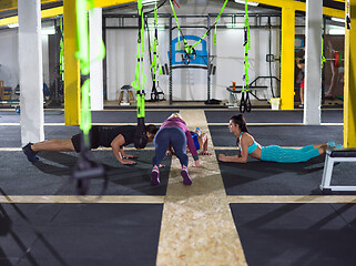 Image showing young healthy people doing pushups