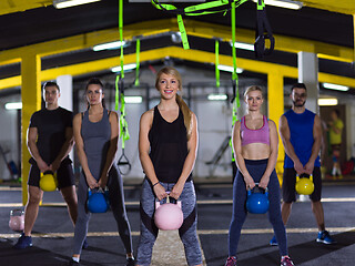 Image showing athletes doing exercises with kettlebells