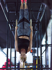 Image showing woman working out with personal trainer on gymnastic rings